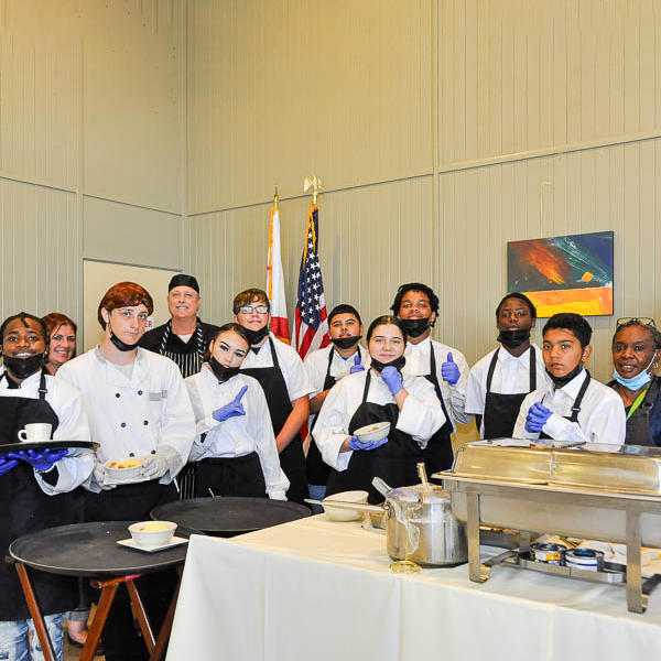 Culinary students dressed in serving aprons