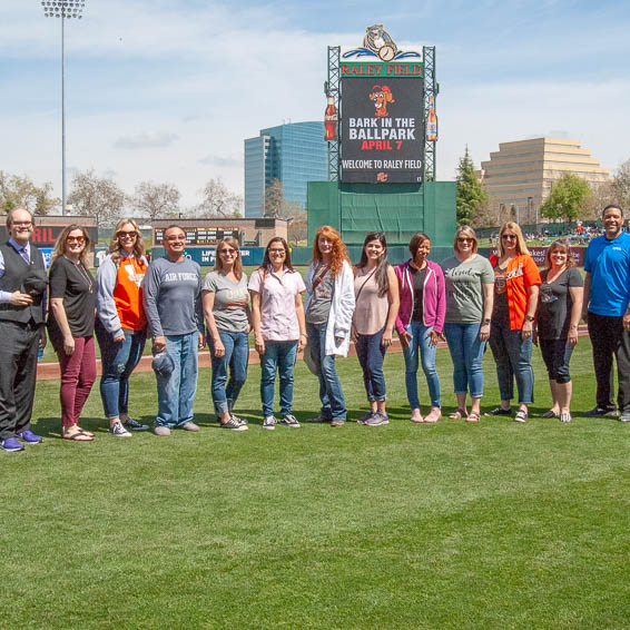 District Teachers of the Year 2019 posing on-field at Raley Field