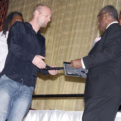 Client shaking hands as he receives a certificate