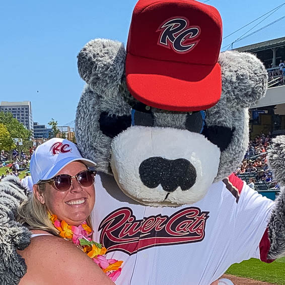 Yvonne Thornton posing with River Cats mascot